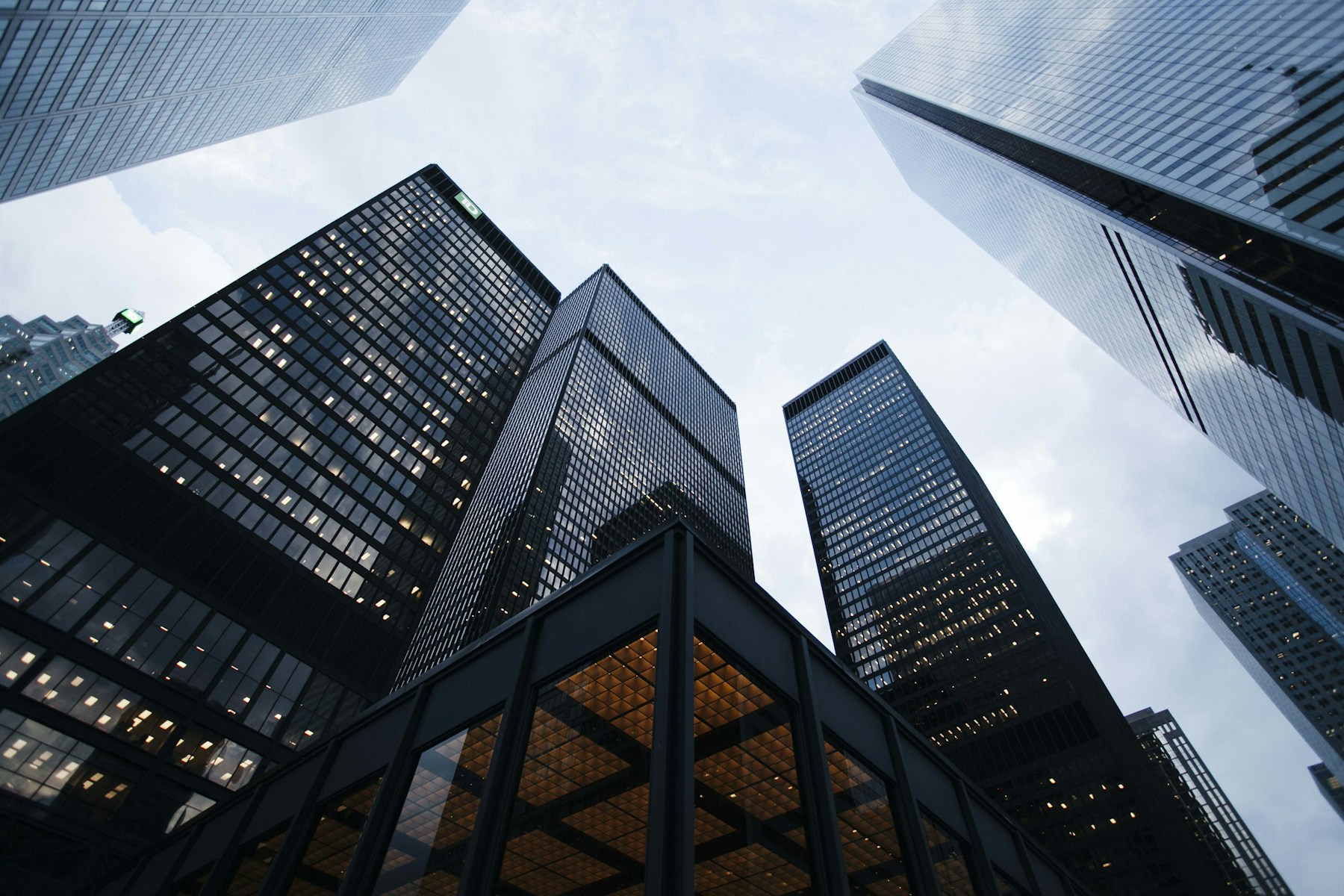 Looking up between contemporary glass office towers