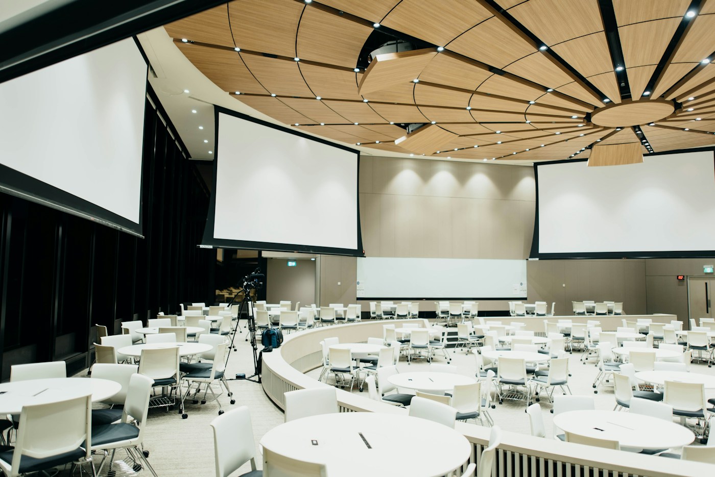 Conference venue arranged with tables and seating for an event